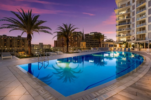 view of pool at dusk