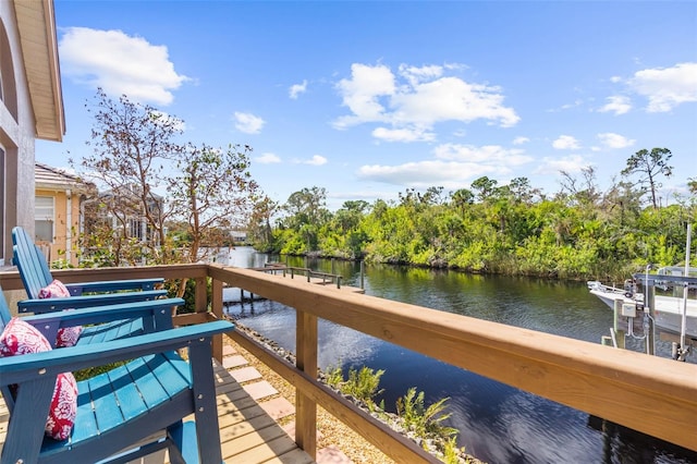 view of dock featuring a water view and a balcony