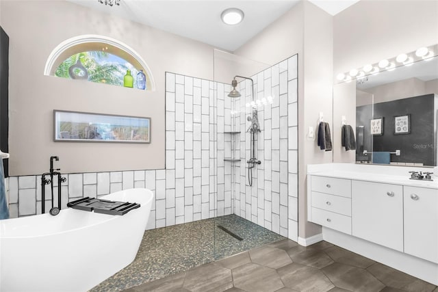 bathroom featuring tile patterned floors, vanity, and separate shower and tub