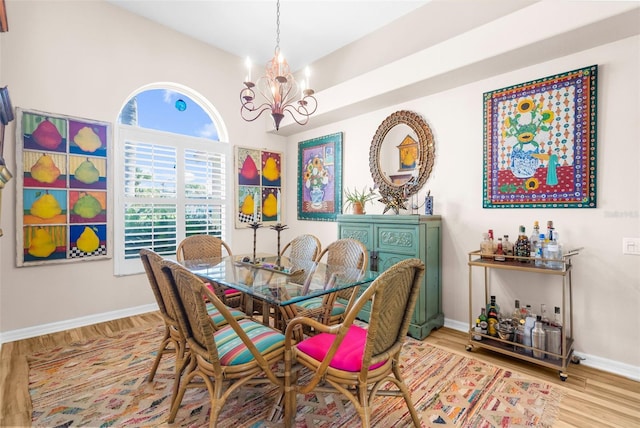 dining room featuring light hardwood / wood-style floors and a chandelier