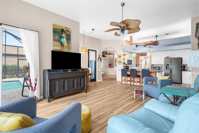 living room featuring light wood-type flooring and ceiling fan