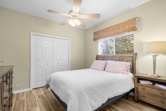 bedroom featuring ceiling fan, a closet, and light hardwood / wood-style flooring