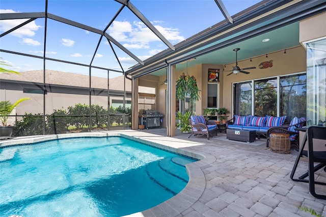 view of pool with glass enclosure, ceiling fan, a grill, an outdoor living space, and a patio area