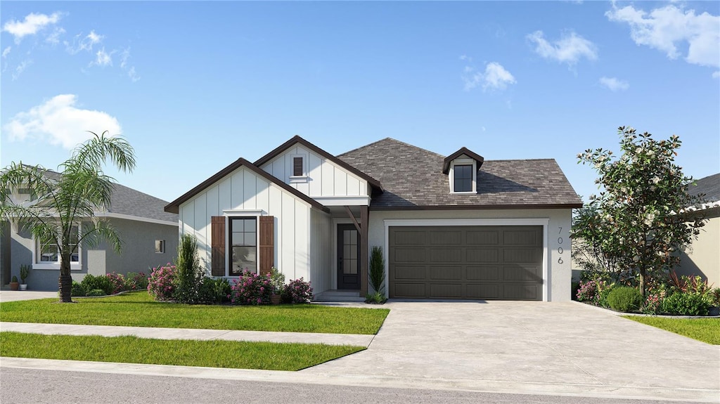 view of front of home featuring a front yard and a garage