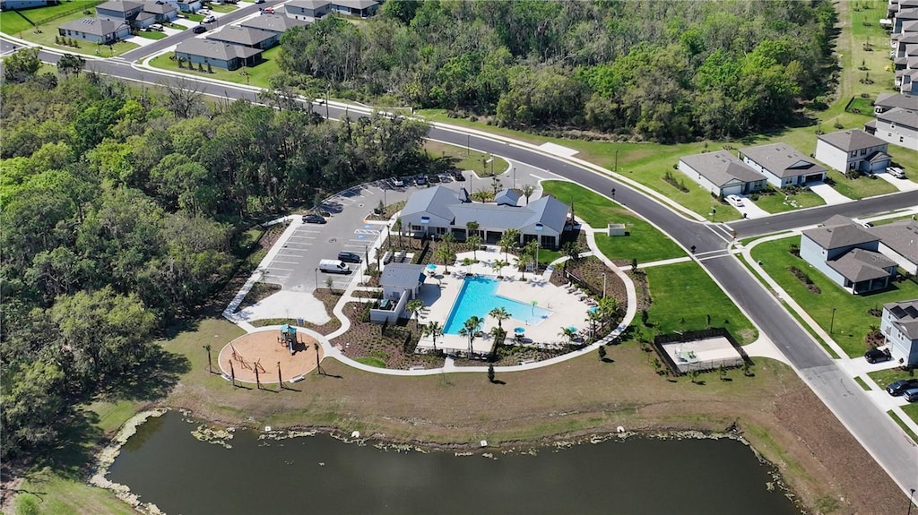 drone / aerial view with a residential view and a water view