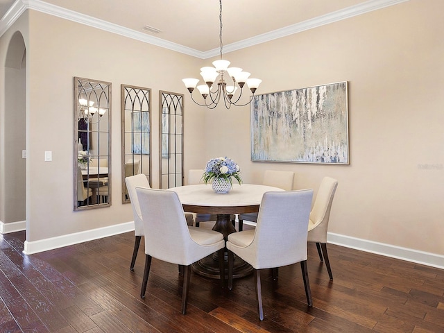 dining area featuring ornamental molding, an inviting chandelier, and dark wood-type flooring