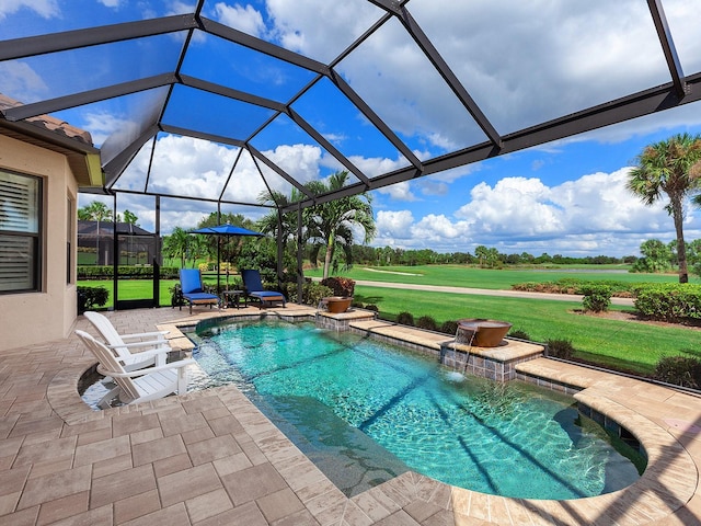 view of swimming pool with a yard, glass enclosure, pool water feature, and a patio area