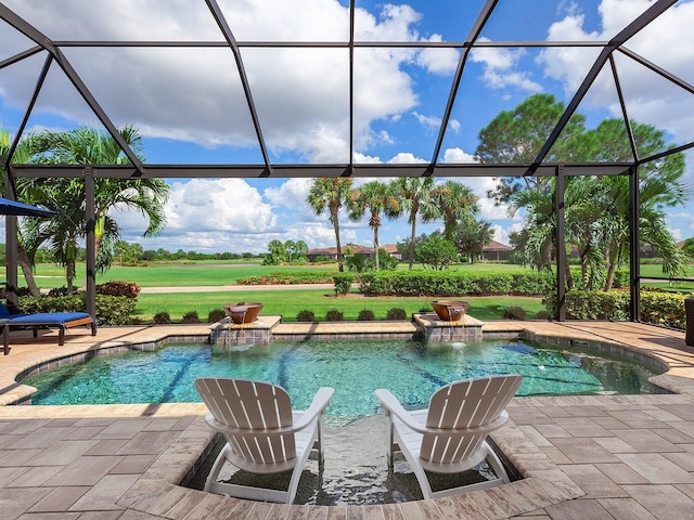 view of pool with a lanai, pool water feature, and a patio area