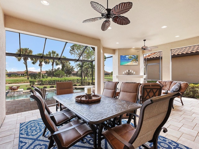 view of patio with ceiling fan and a lanai