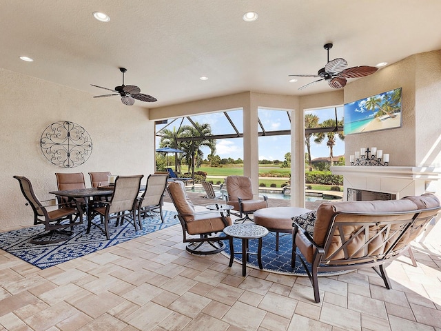 view of patio featuring a lanai and ceiling fan