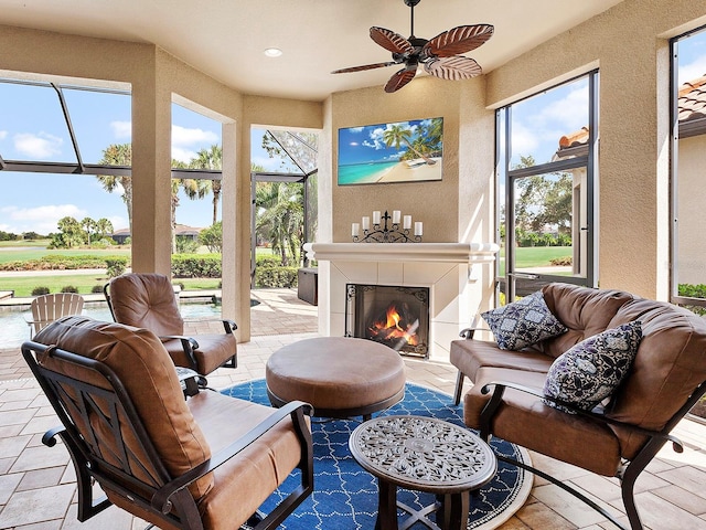 exterior space featuring a fireplace and ceiling fan