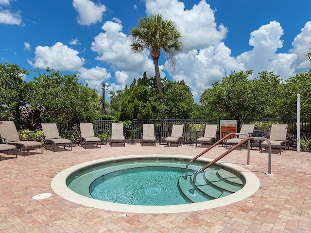 view of swimming pool featuring a patio area and a hot tub