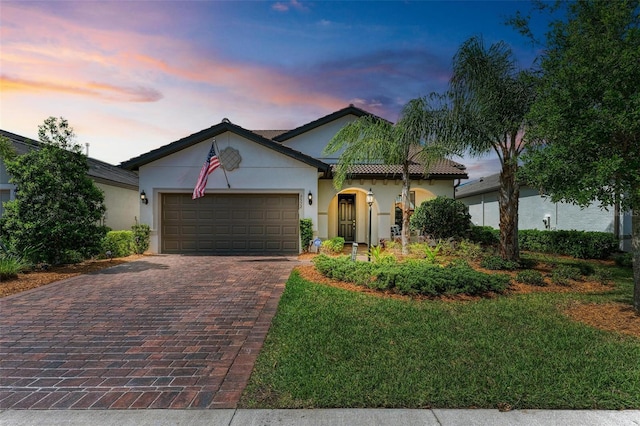 view of front facade featuring a garage and a yard