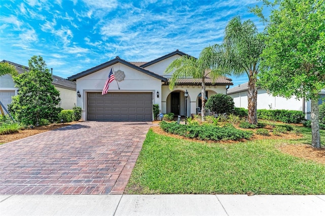 view of front of home with a front lawn and a garage