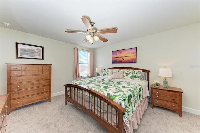 bedroom with ceiling fan and light colored carpet