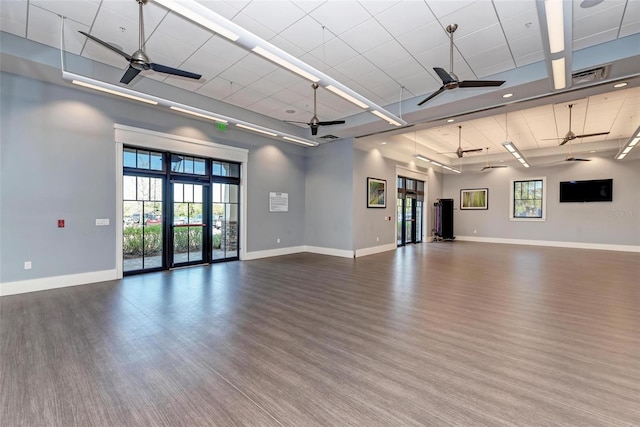 unfurnished room with hardwood / wood-style floors, a healthy amount of sunlight, and ceiling fan