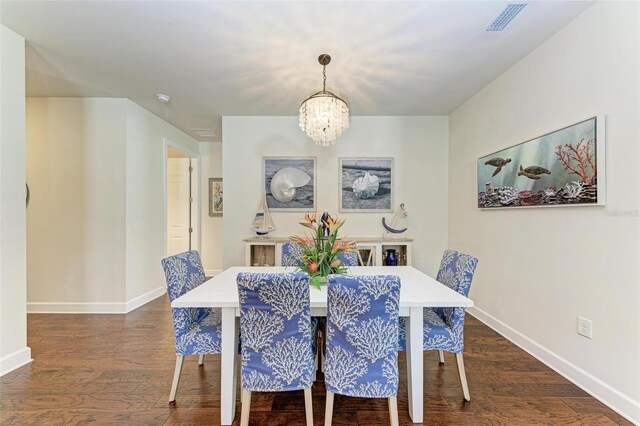 7572 Viola Loop, Lakewood Ranch, FL 34202 - dining area with dark wood-style flooring and a chandelier