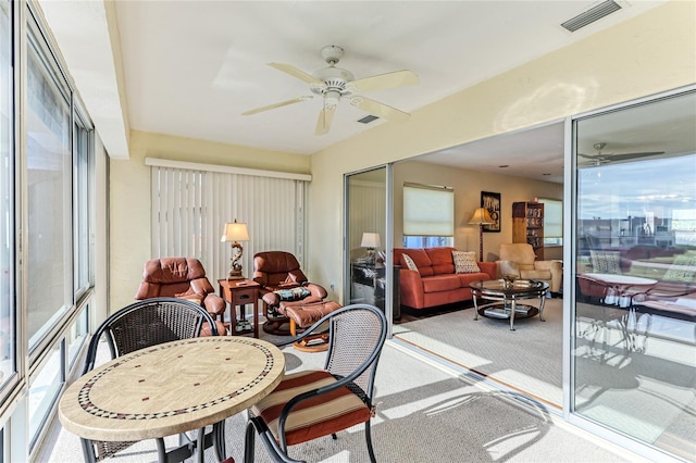 sunroom featuring ceiling fan