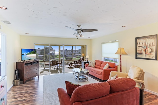 living room featuring wood-type flooring and ceiling fan