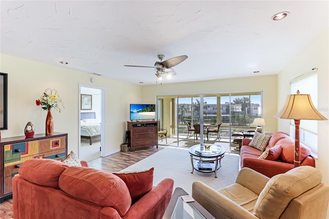 living room featuring ceiling fan and hardwood / wood-style floors