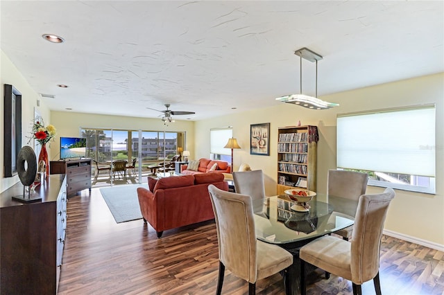 dining area featuring ceiling fan and dark hardwood / wood-style flooring