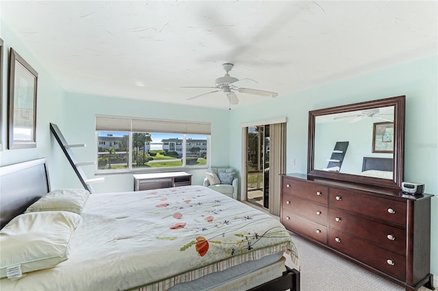 bedroom with ceiling fan and light carpet