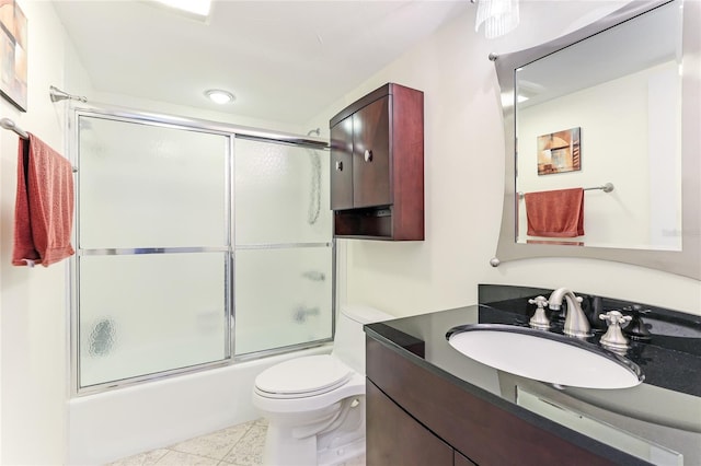 full bathroom with enclosed tub / shower combo, tile patterned flooring, vanity, and toilet