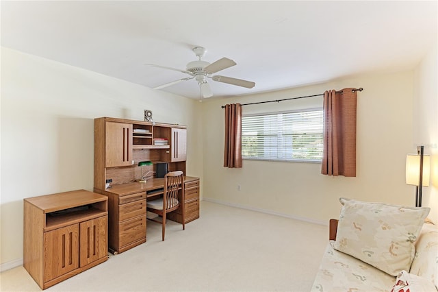 carpeted office featuring ceiling fan