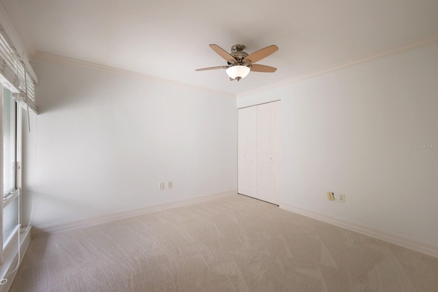 unfurnished room featuring crown molding, carpet flooring, and ceiling fan