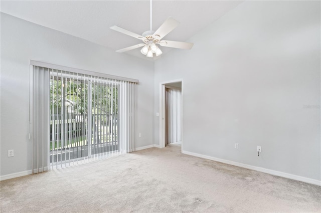 spare room with high vaulted ceiling, ceiling fan, and light colored carpet