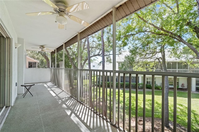 unfurnished sunroom with ceiling fan