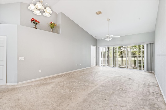 unfurnished living room with ceiling fan with notable chandelier, carpet, and high vaulted ceiling