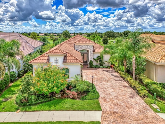 mediterranean / spanish-style house with a front lawn