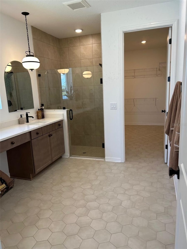 11709 Capstan Pl, Parrish, FL 34219 - full bathroom featuring a stall shower, vanity, a walk in closet, and recessed lighting