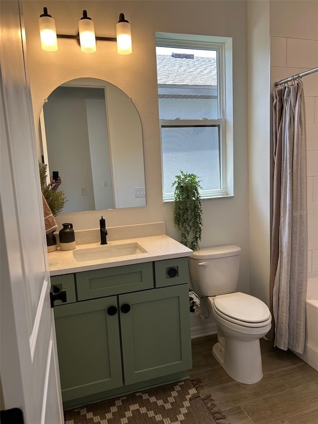 11709 Capstan Pl, Parrish, FL 34219 - bathroom with toilet, vanity, wood finished floors, and shower / bath combo