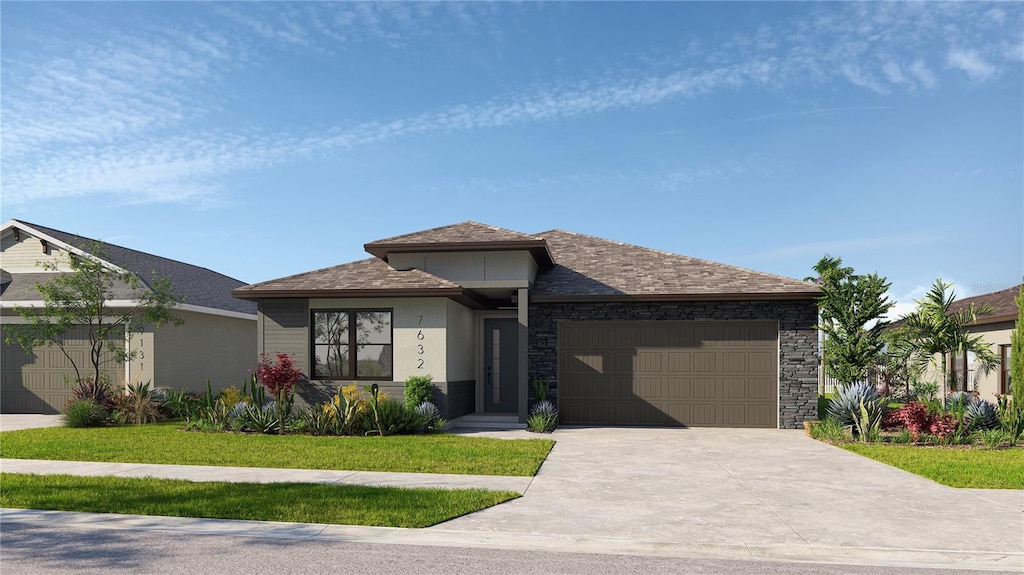 view of front of home with a garage and a front lawn