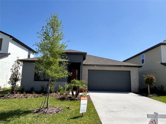 11718 Capstan Pl, Parrish, FL 34219 - view of front of home featuring an attached garage, concrete driveway, and a front yard