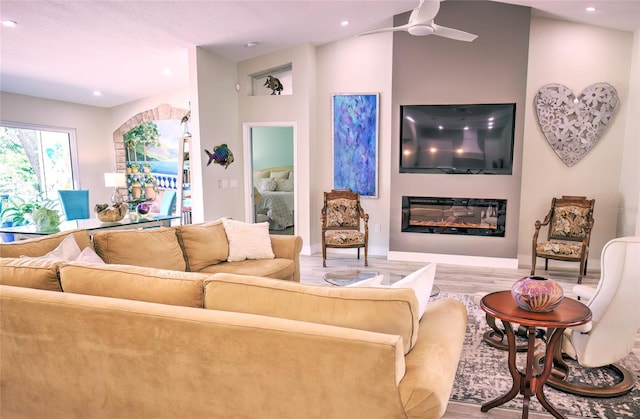 living room featuring light hardwood / wood-style flooring and ceiling fan