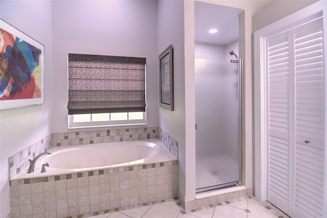 bathroom featuring tile patterned flooring and independent shower and bath