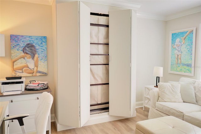 interior space with ornamental molding, a baseboard heating unit, and light hardwood / wood-style flooring