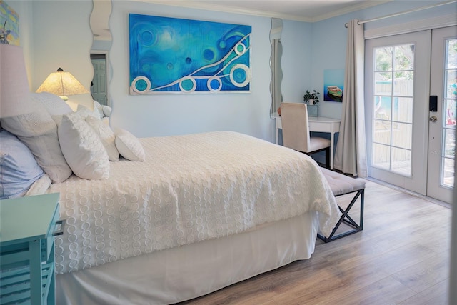 bedroom with french doors, hardwood / wood-style flooring, access to exterior, and crown molding