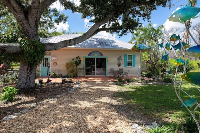 rear view of house featuring a lawn and a patio area