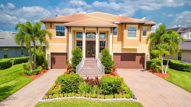 view of front of home featuring a garage and a front lawn