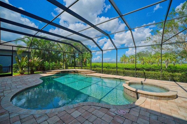 view of pool featuring an in ground hot tub, glass enclosure, and a patio area