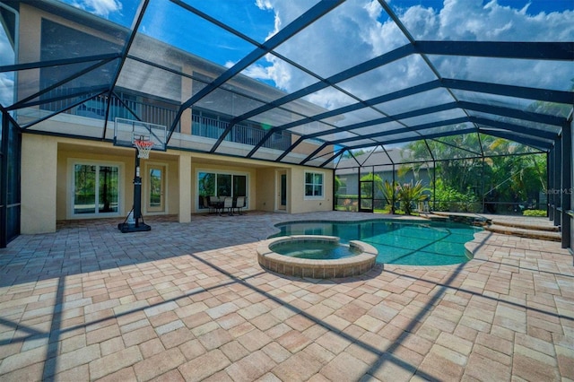 view of swimming pool with a patio area, an in ground hot tub, and glass enclosure