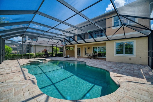 view of swimming pool with an in ground hot tub, a patio, and glass enclosure