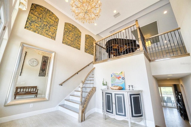 stairway with a notable chandelier and a high ceiling