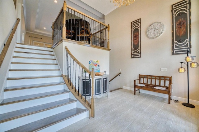 staircase featuring a towering ceiling