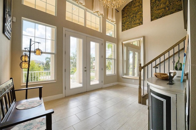 doorway to outside with french doors and a towering ceiling