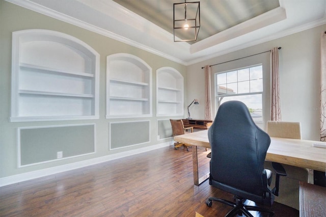 office with a tray ceiling, crown molding, dark hardwood / wood-style floors, and built in features